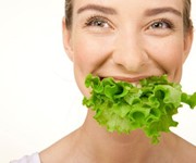 Healthy woman eating lettuce
